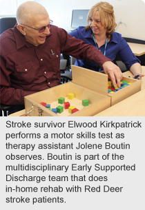 Stroke survivor Elwood Kirkpatrick performs a motor skills test as therapy assistant Jolene Boutin observes.