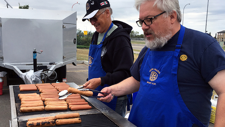 The grill team kept it sizzling by serving around 1,400 burgers and hotdogs at a free barbecue throughout the day, made possible by generous donors and sponsors in the Grande Prairie community.