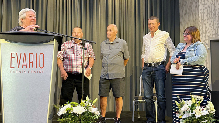 Margaret Lidstone, at podium, thanks donor mom Kelli Reimer and three of her son’s organ recipients, centre from left: Paul Gauthier, Philip Marose and John Reimer.