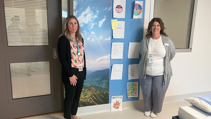 Kellie Quian, left, and Carla Marie Seal Riemann pose next to one of the personalized walls a patient ‘owns’ during their stay at the specialized Psychiatric Intensive Care Unit (PICU) at South Health Campus in Calgary.